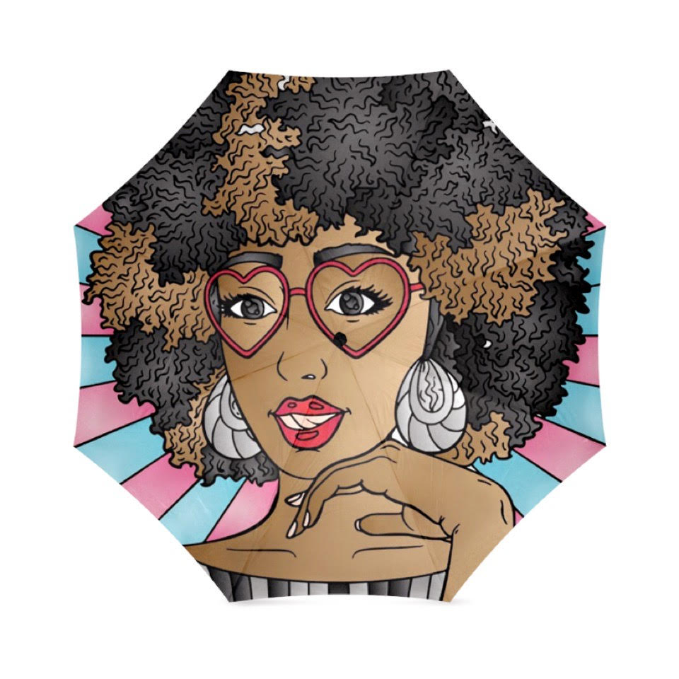 A colorful umbrella with bold pinks and blue colors, featuring a vibrant cartoon illustration of a black woman with a natural afro hairstyle, wearing heart-shaped glasses, and bright red lipstick, and bold earrings. 