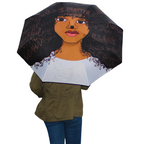 I Matter Umbrella that features deep brown and black accents and a white  lower area. The umbrella features a woman with words across her forehead that says "I Matter". Words featured in each strand of her hair like "beautiful", "queen", "human", "unique". 