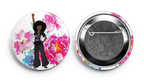 a pin showing a black girl holding her fist up 